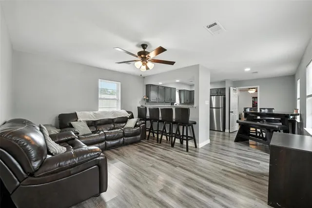 a living room with furniture and wooden floor