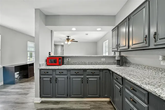 a kitchen with stainless steel appliances granite countertop a sink stove and cabinets
