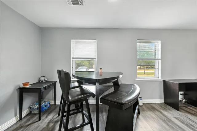 a view of a dining room with furniture and wooden floor