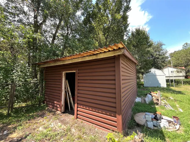 a backyard of a house with barbeque oven