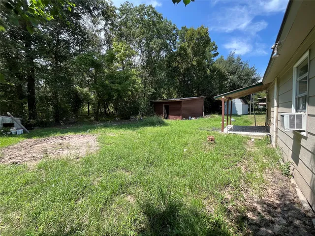 a view of a backyard with a small cabin