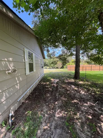 a view of a backyard with large trees
