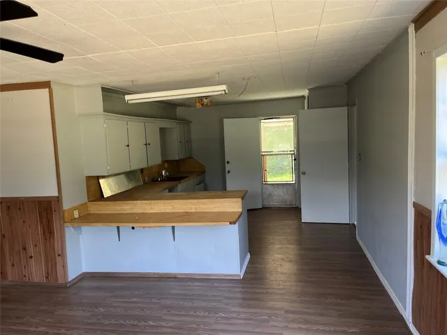 a view of a room with wooden floor