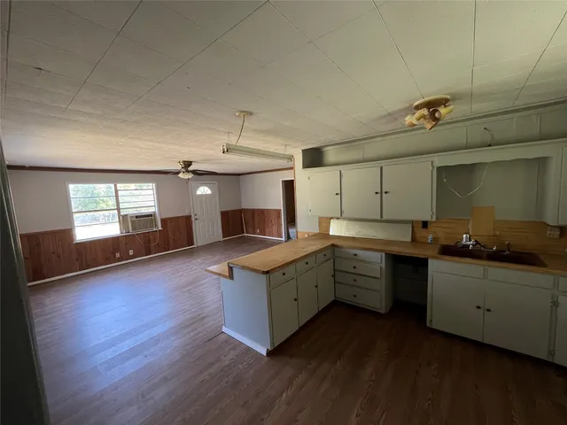 a kitchen with sink cabinets and wooden floor