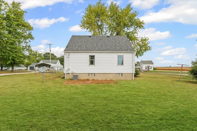 a backyard of a house with table and chairs