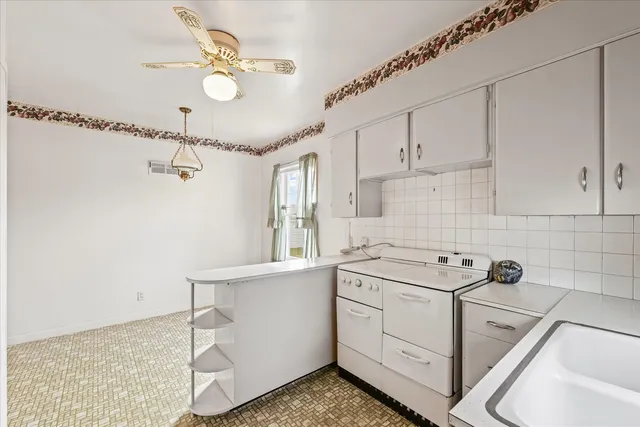 a utility room with cabinets washer and dryer