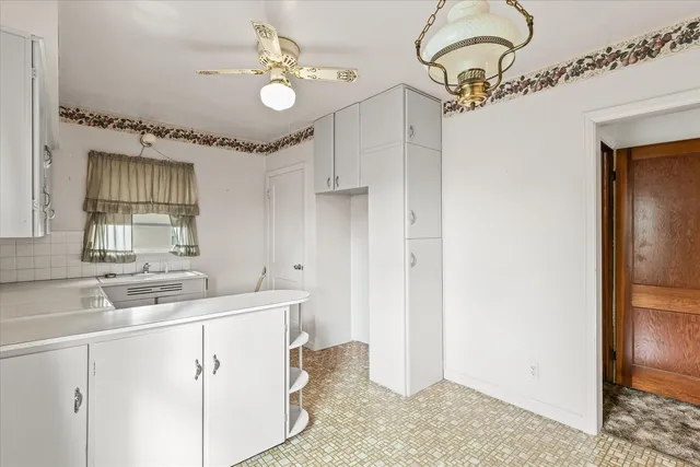 a kitchen with a sink and chandelier