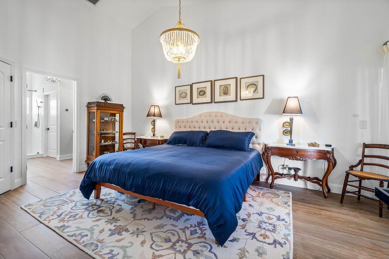 8195 Mooring Circle Boynton Beach, FL 33472 - Photo 11 of 28 a bedroom with a bed and wooden floor