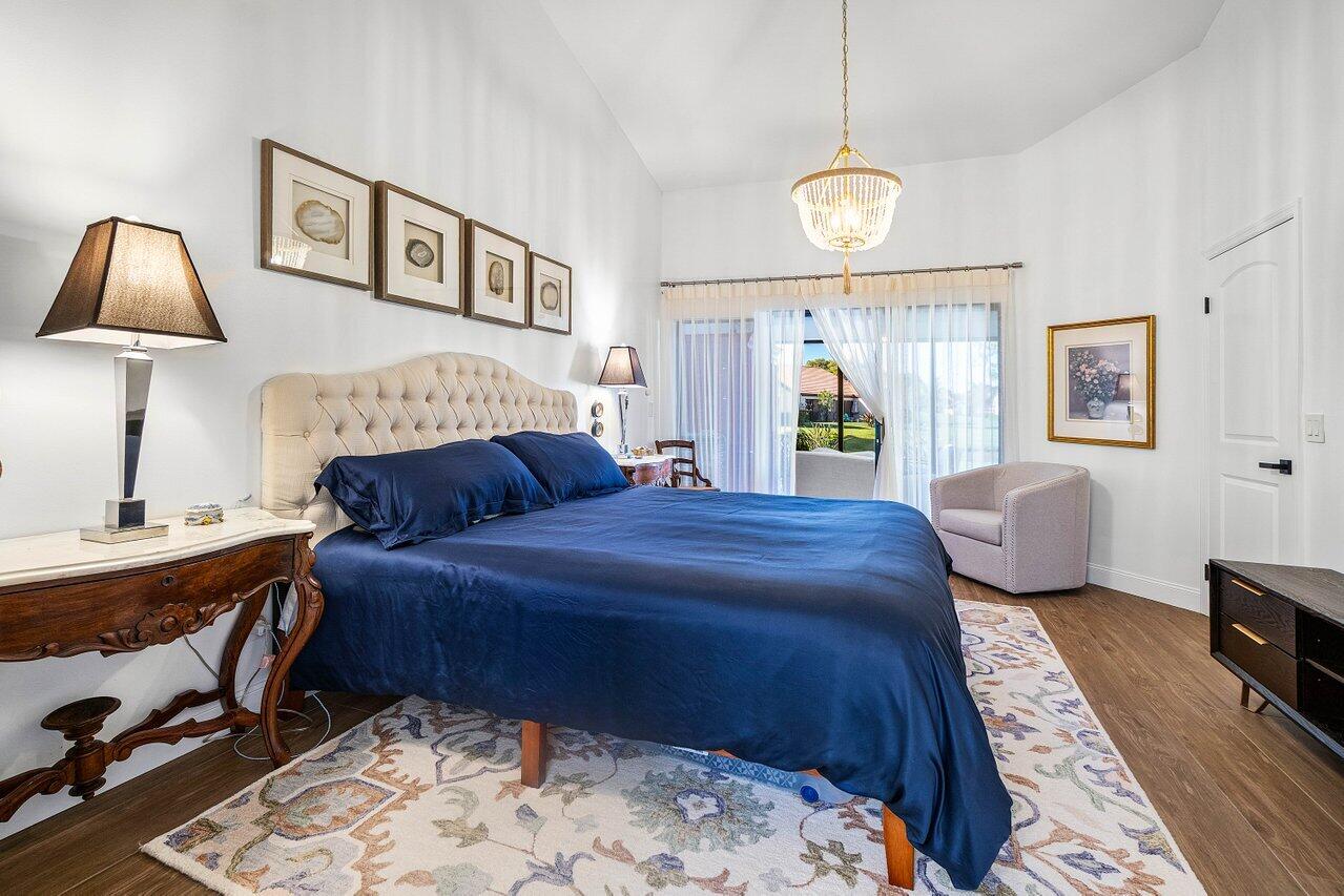 8195 Mooring Circle Boynton Beach, FL 33472 - Photo 12 of 28 a bedroom with a bed window and a table