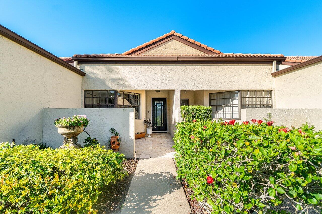 8195 Mooring Circle Boynton Beach, FL 33472 - Photo 18 of 28 a front view of a house with garden