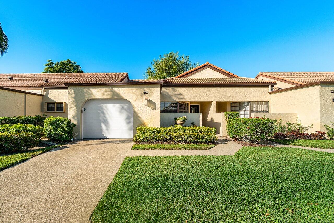8195 Mooring Circle Boynton Beach, FL 33472 - Photo 19 of 28 a front view of a house with a yard