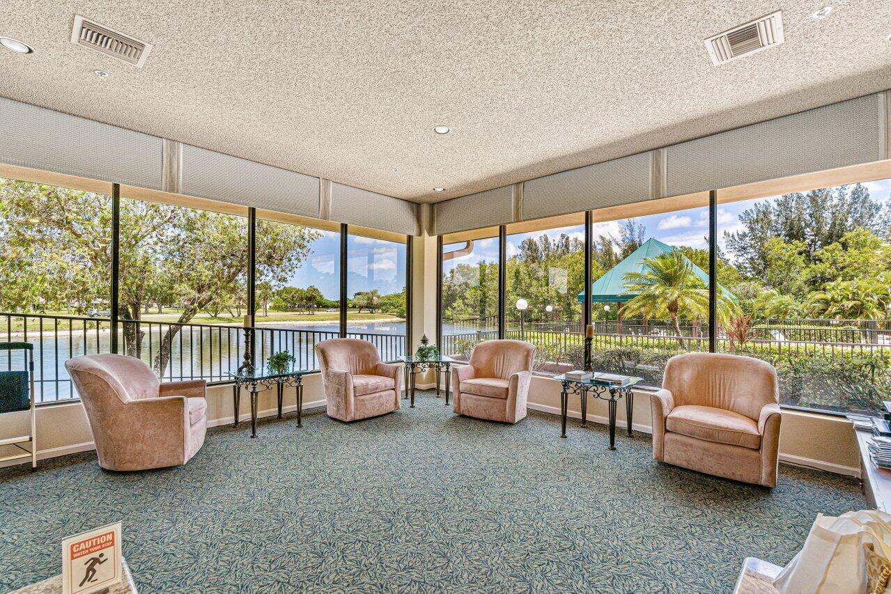 8195 Mooring Circle Boynton Beach, FL 33472 - Photo 20 of 28 a living room with furniture and a floor to ceiling window