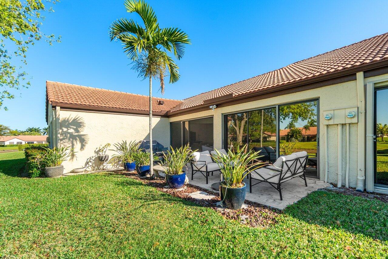 8195 Mooring Circle Boynton Beach, FL 33472 - Photo 3 of 28 a view of an house with backyard porch and furniture