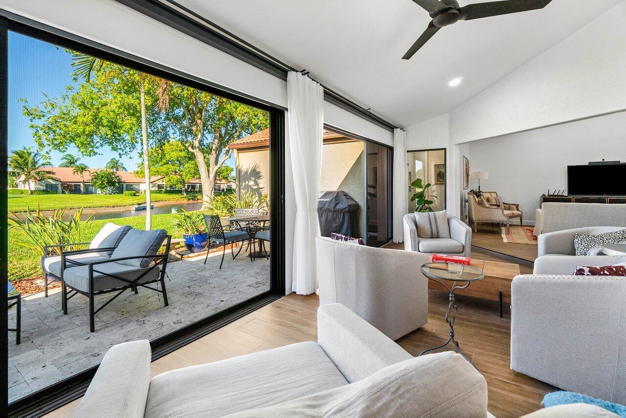 8195 Mooring Circle Boynton Beach, FL 33472 - Photo 4 of 28 a living room with furniture and a floor to ceiling window