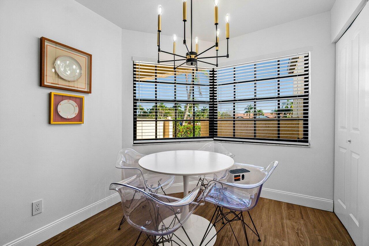 8195 Mooring Circle Boynton Beach, FL 33472 - Photo 10 of 28 a view of a dining room with furniture and wooden floor