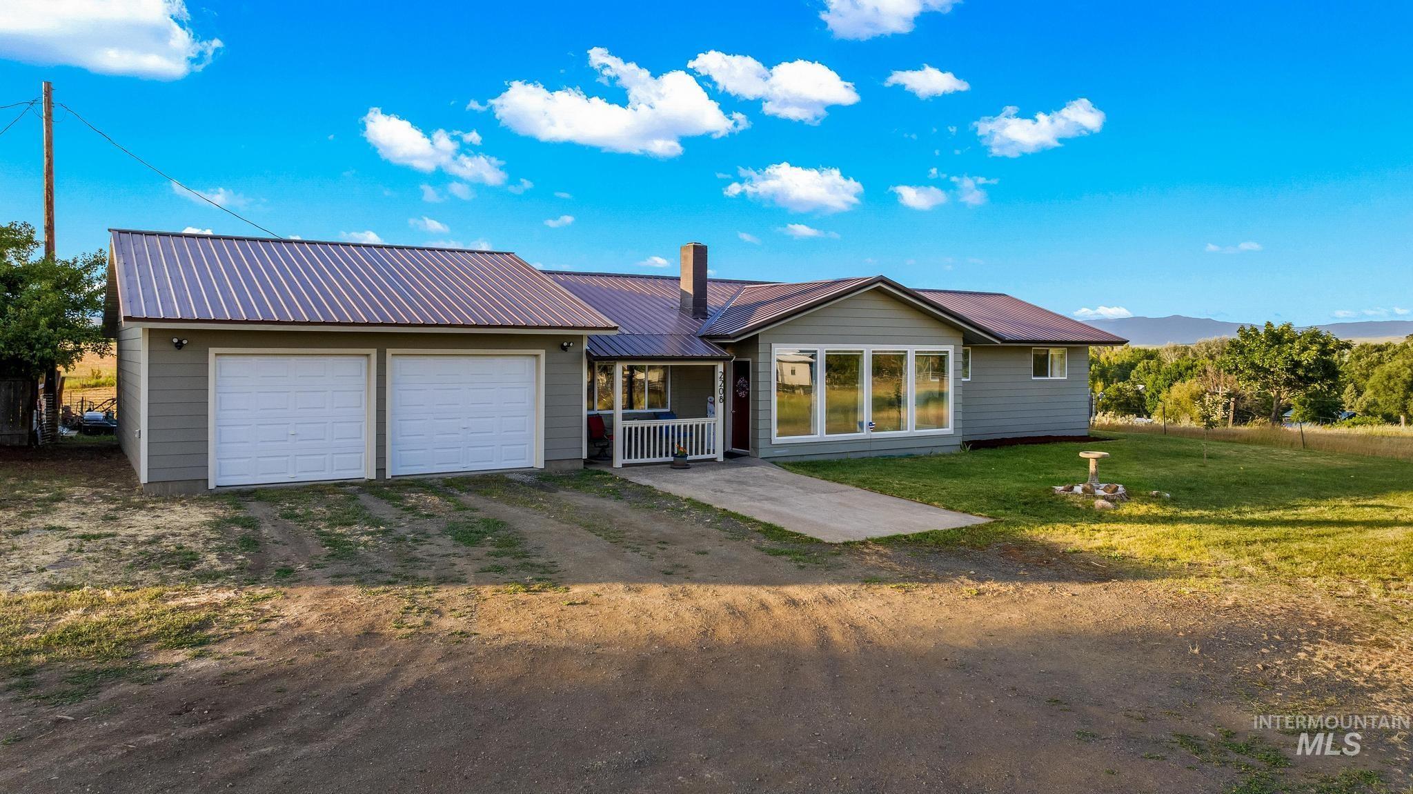 2208 Keithley Creek Road Midvale, ID 83645 - Photo 1 of 45 Ranch-style home with driveway, a garage, a metal roof, and a front lawn