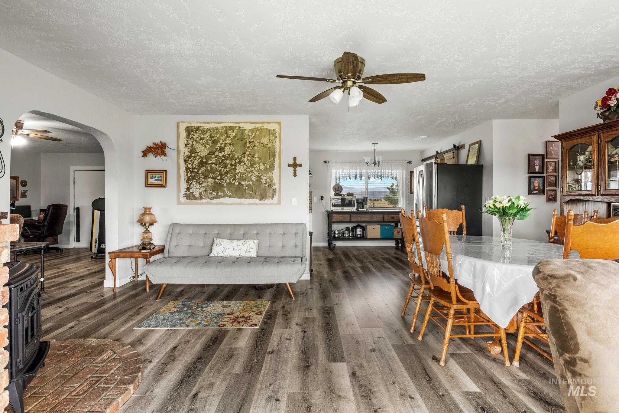 2208 Keithley Creek Road Midvale, ID 83645 - Photo 11 of 45 Dining room with a ceiling fan, wood finished floors, arched walkways, and a textured ceiling