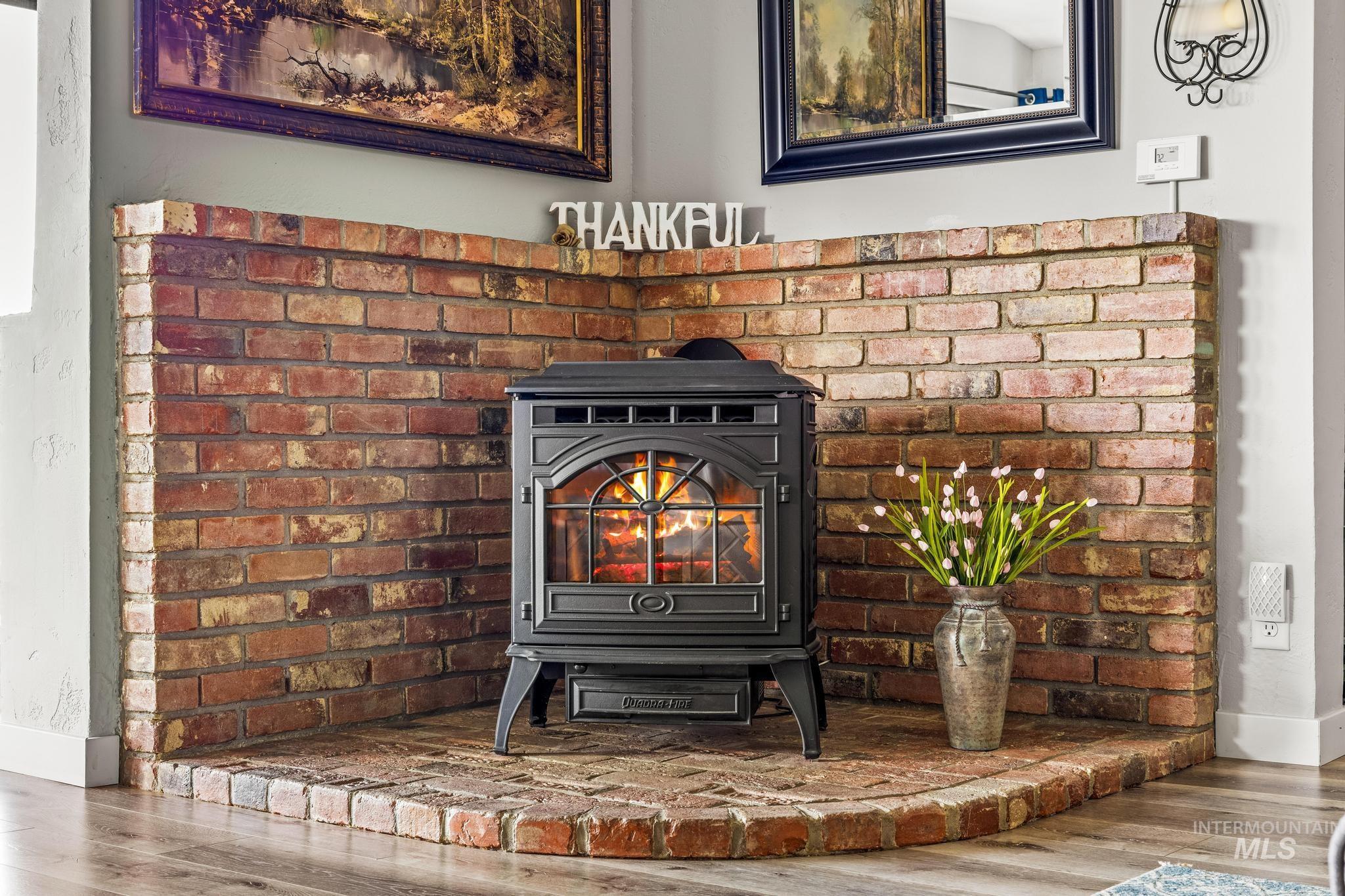 2208 Keithley Creek Road Midvale, ID 83645 - Photo 19 of 45 Detailed view of a wood stove and wood finished floors