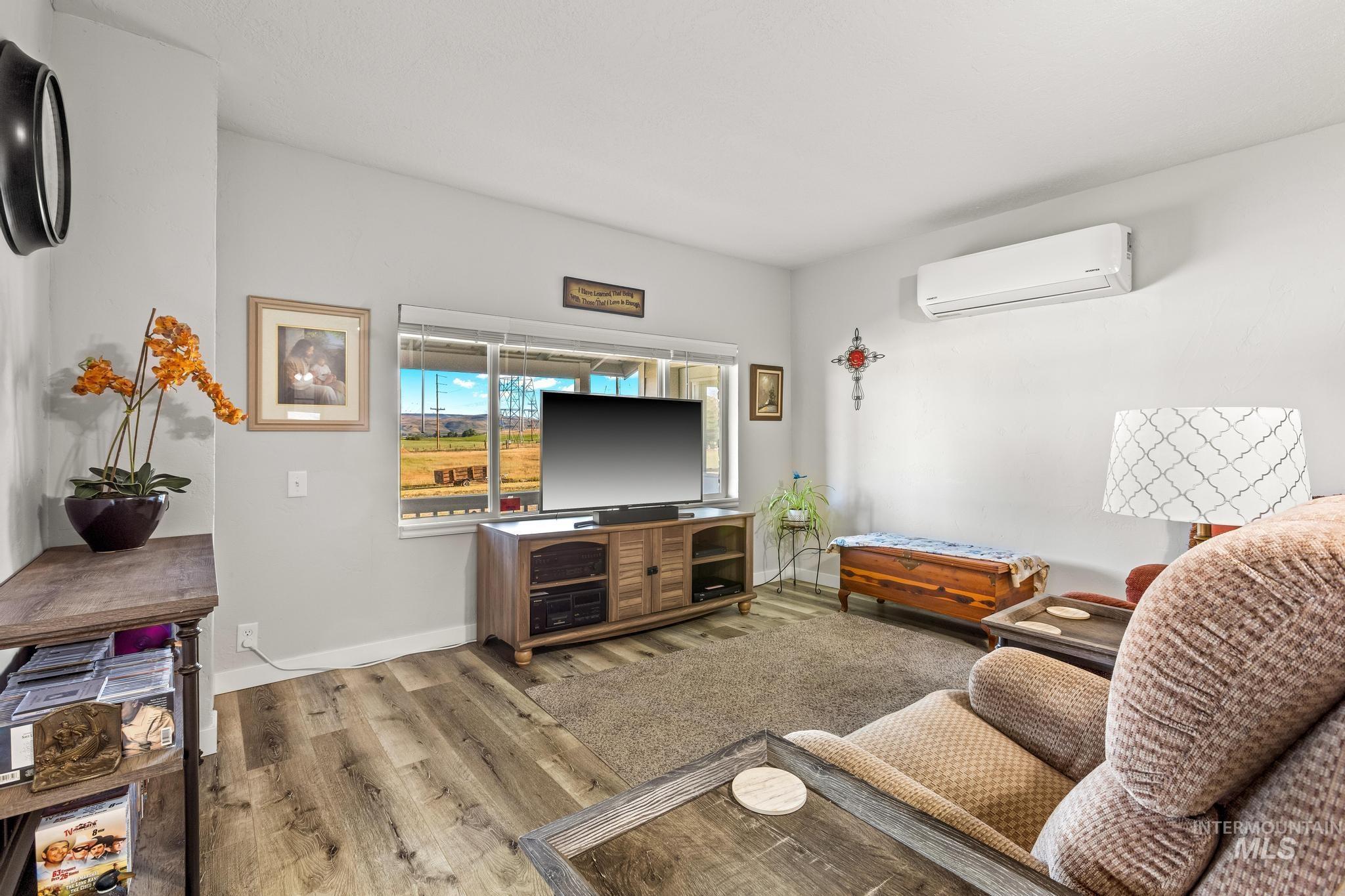 2208 Keithley Creek Road Midvale, ID 83645 - Photo 21 of 45 Living room with a wall unit AC and light wood-style flooring