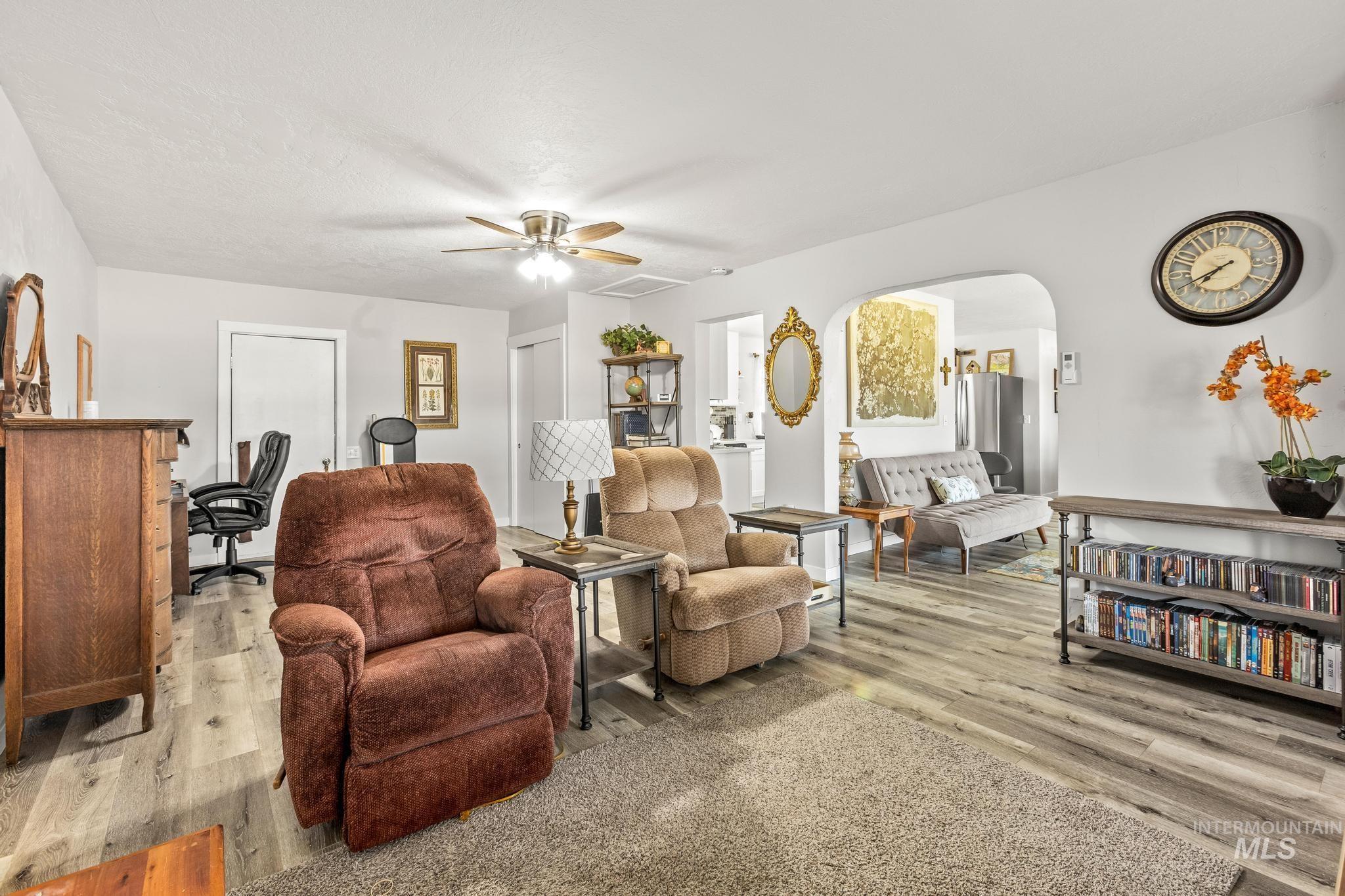 2208 Keithley Creek Road Midvale, ID 83645 - Photo 22 of 45 Living room with wood finished floors, arched walkways, and ceiling fan