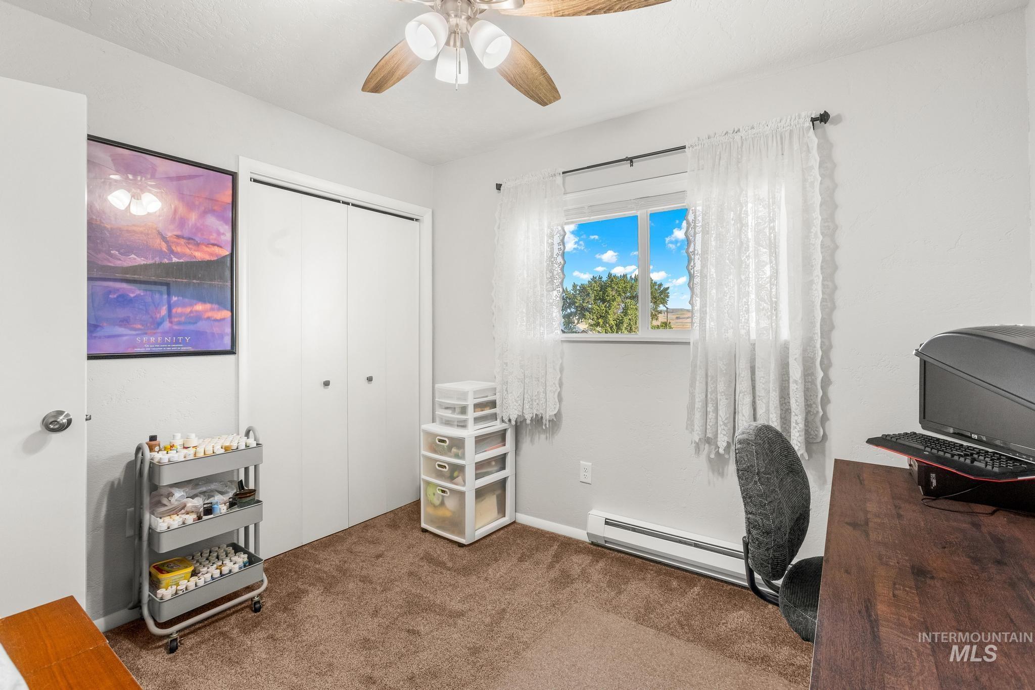 2208 Keithley Creek Road Midvale, ID 83645 - Photo 32 of 45 Carpeted office featuring a baseboard radiator and ceiling fan