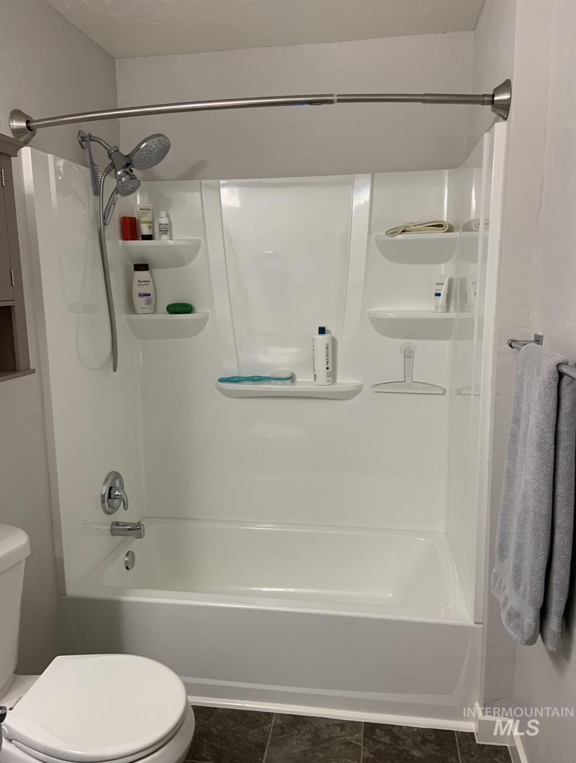 2208 Keithley Creek Road Midvale, ID 83645 - Photo 44 of 45 Full bath with washtub / shower combination and dark tile patterned flooring