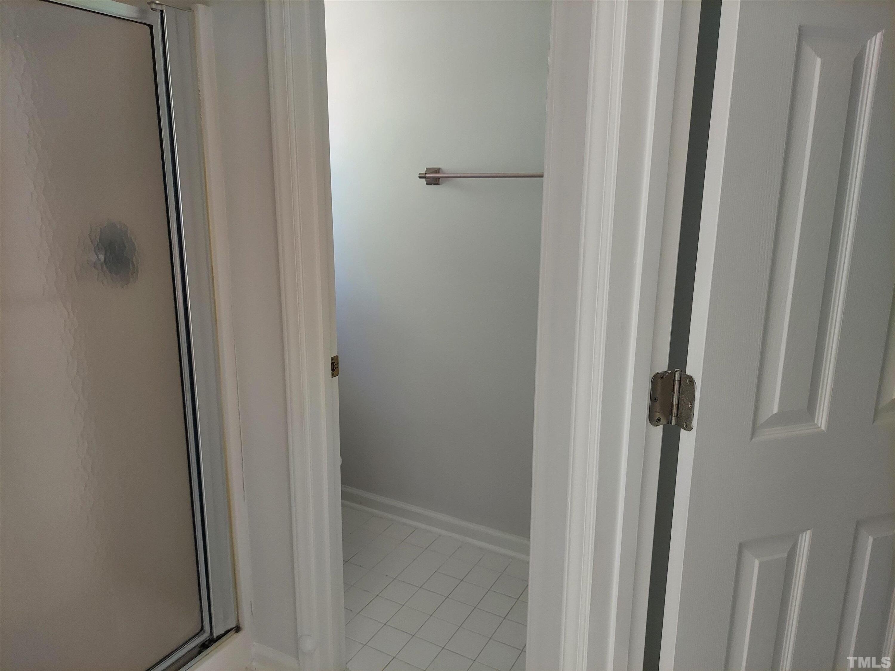224 Crossfire Road Holly Springs, NC 27540 - Photo 23 of 43 a bathroom with a glass shower door