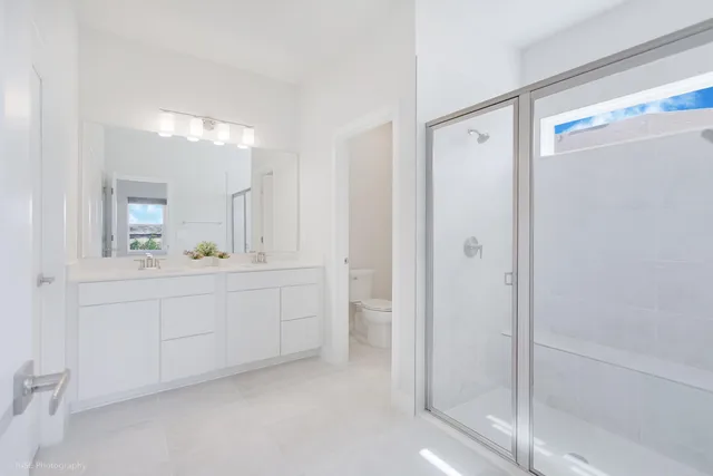 a bathroom with a shower sink and mirror
