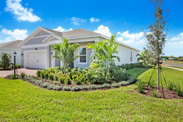 a view of a house with a yard and plants