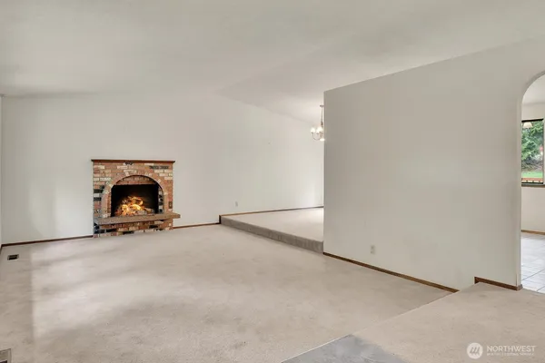 an empty room with furniture and a fireplace