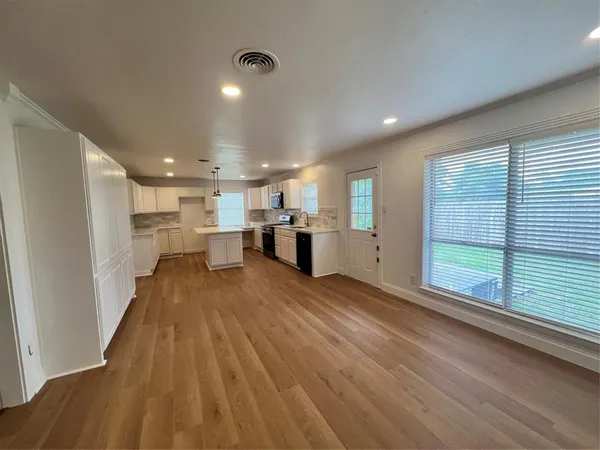 a view of kitchen with refrigerator and window