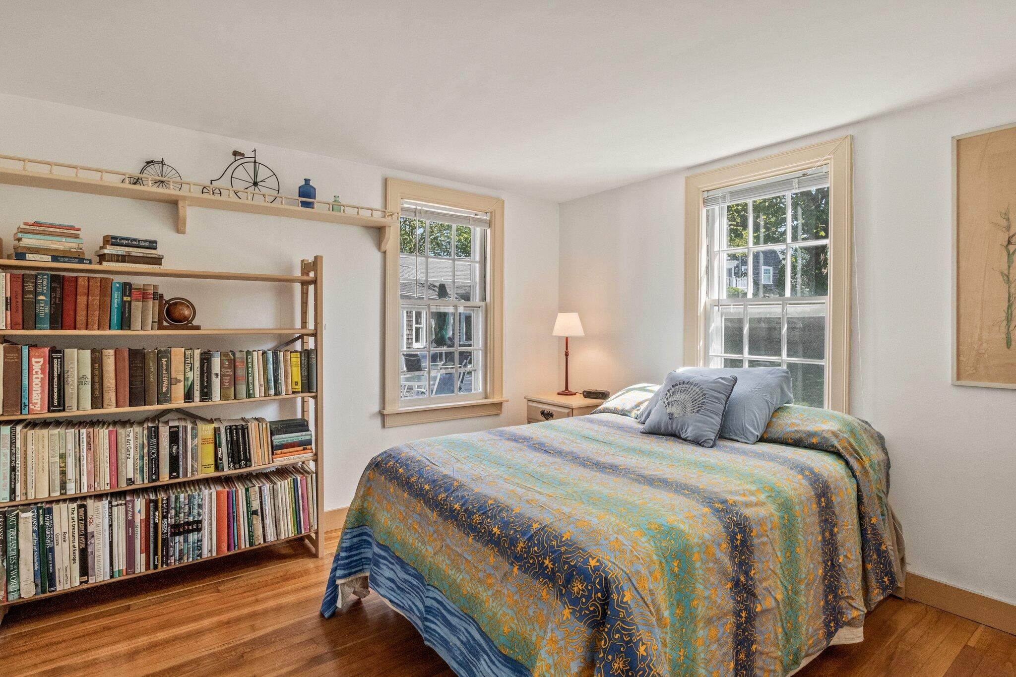 31 Mill Pond Road Chatham, MA 02633 - Photo 16 of 37 a bedroom with a bed a book shelf and a window
