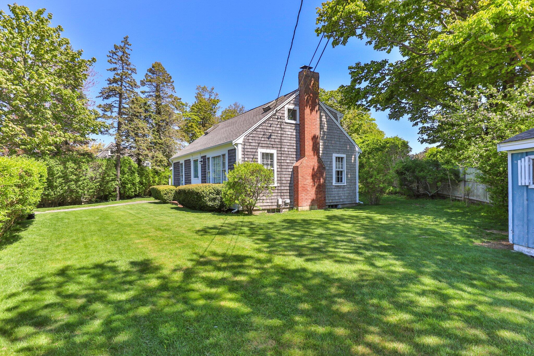 31 Mill Pond Road Chatham, MA 02633 - Photo 2 of 37 a view of a house with backyard and garden