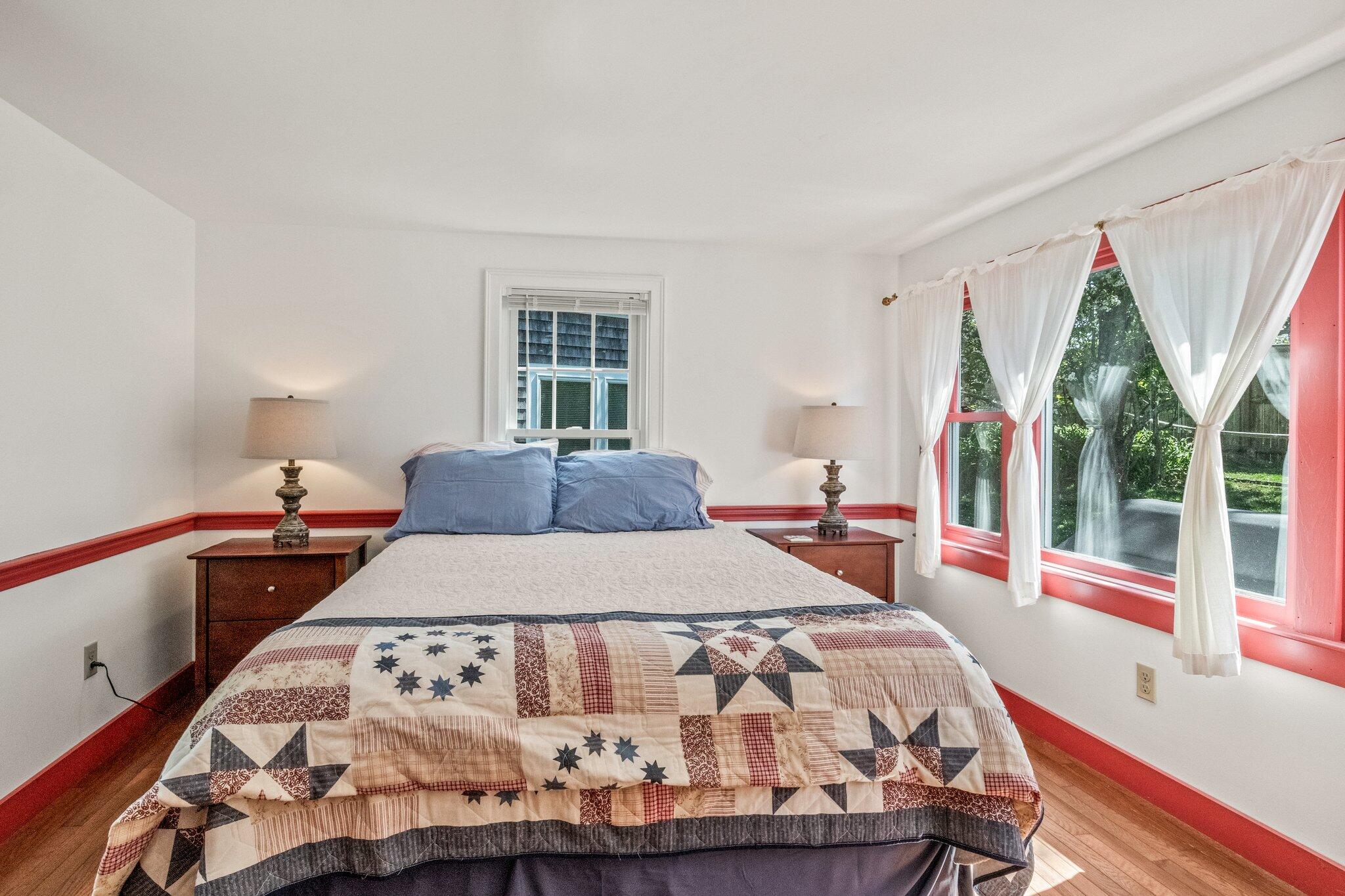 31 Mill Pond Road Chatham, MA 02633 - Photo 21 of 37 a bedroom with a bed and a large window with outer view