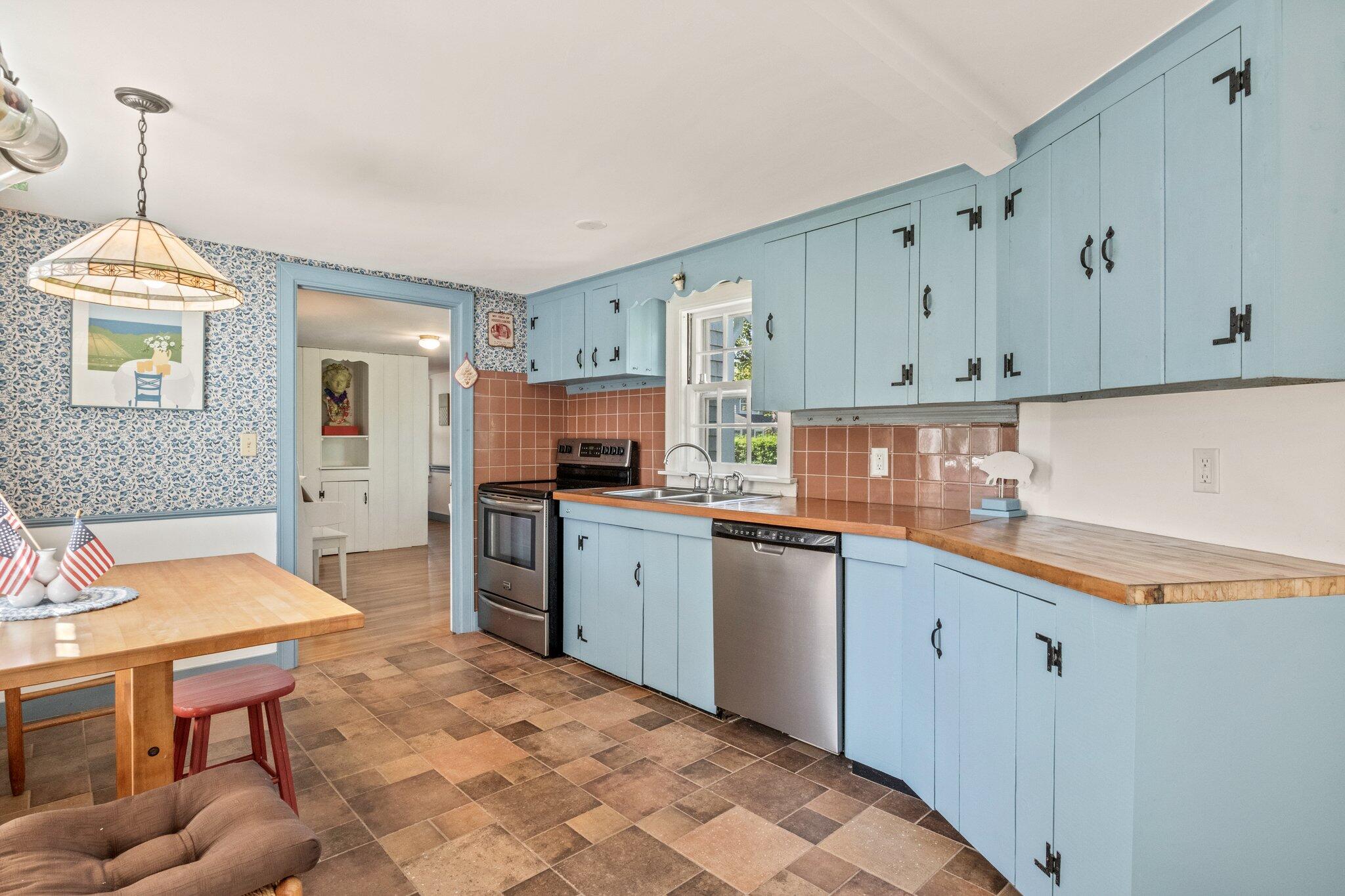 31 Mill Pond Road Chatham, MA 02633 - Photo 4 of 37 a kitchen with granite countertop a sink cabinets stainless steel appliances and a window