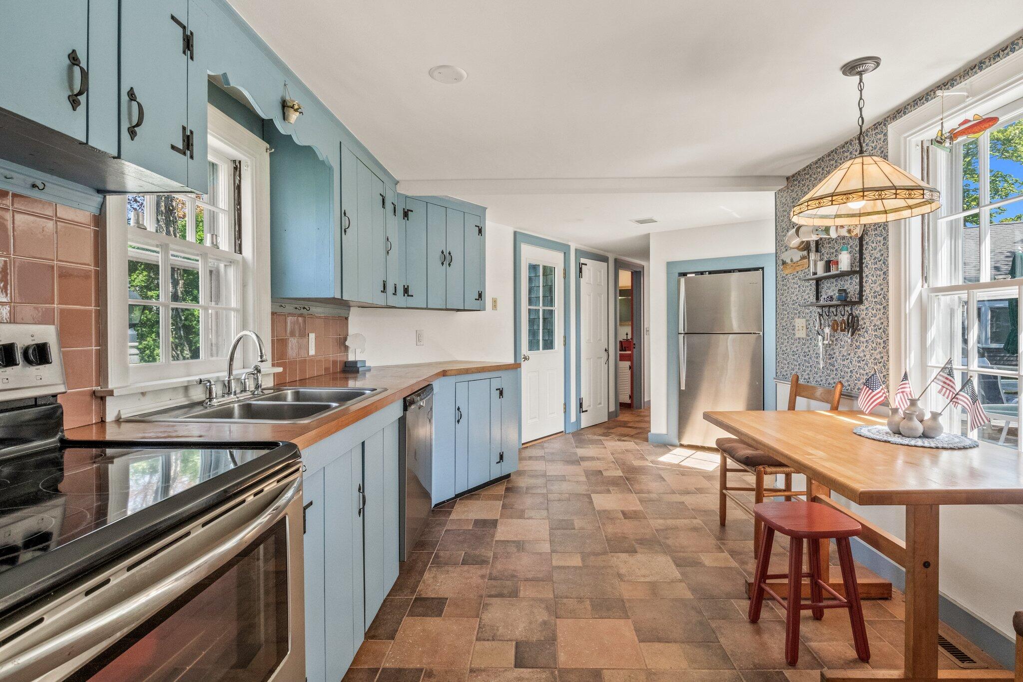31 Mill Pond Road Chatham, MA 02633 - Photo 7 of 37 a kitchen with stainless steel appliances granite countertop a sink and cabinets