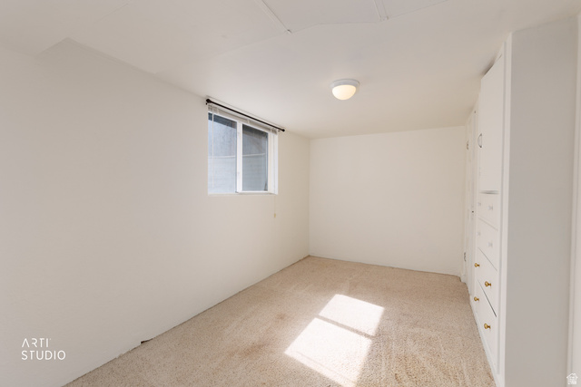 146 West 200 N Street Springville, UT 84663 - Photo 20 of 29 Carpeted room with a double-pane window, flush-mount ceiling light, and built-in white cabinetry featuring brass hardware