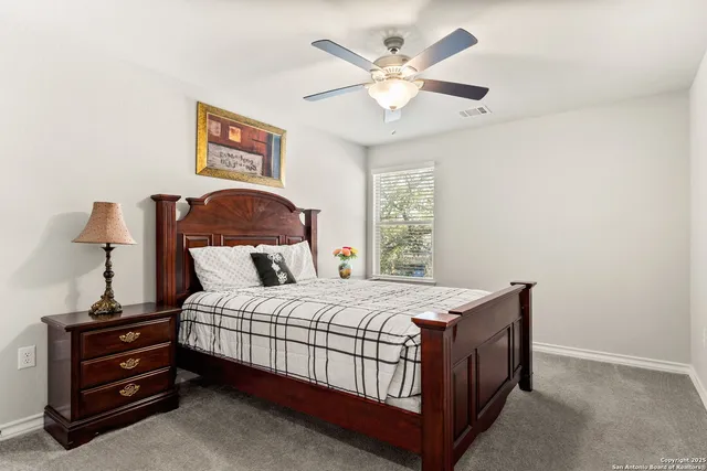 a bedroom with a bed chandelier and a window