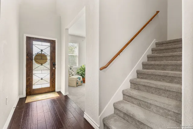a view of entryway with wooden floor and stairs