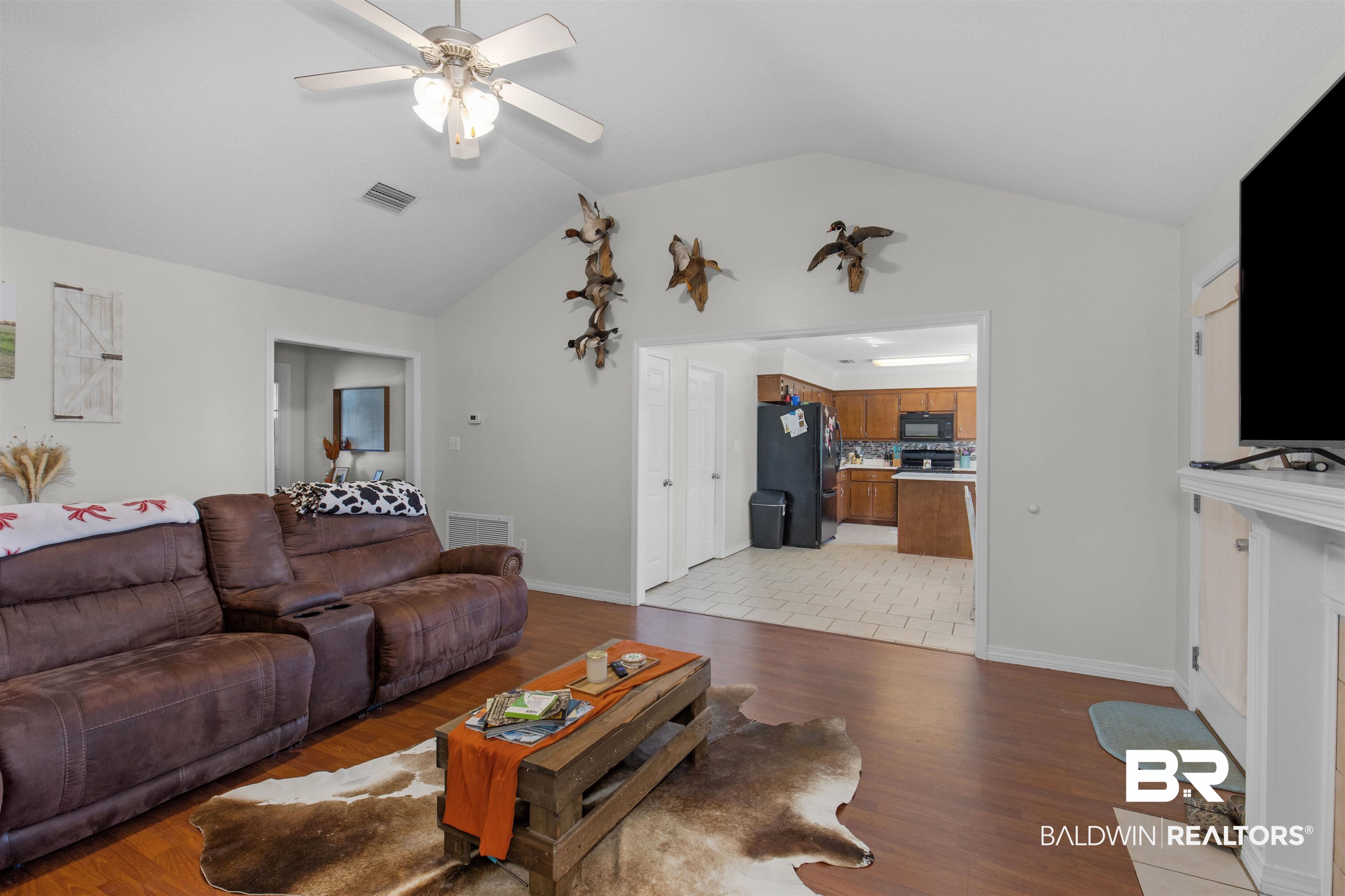 4950 Clealand Court Mobile, AL 36695 - Photo 5 of 20 Living room featuring vaulted ceiling, ceiling fan, light wood-type flooring, and visible vents