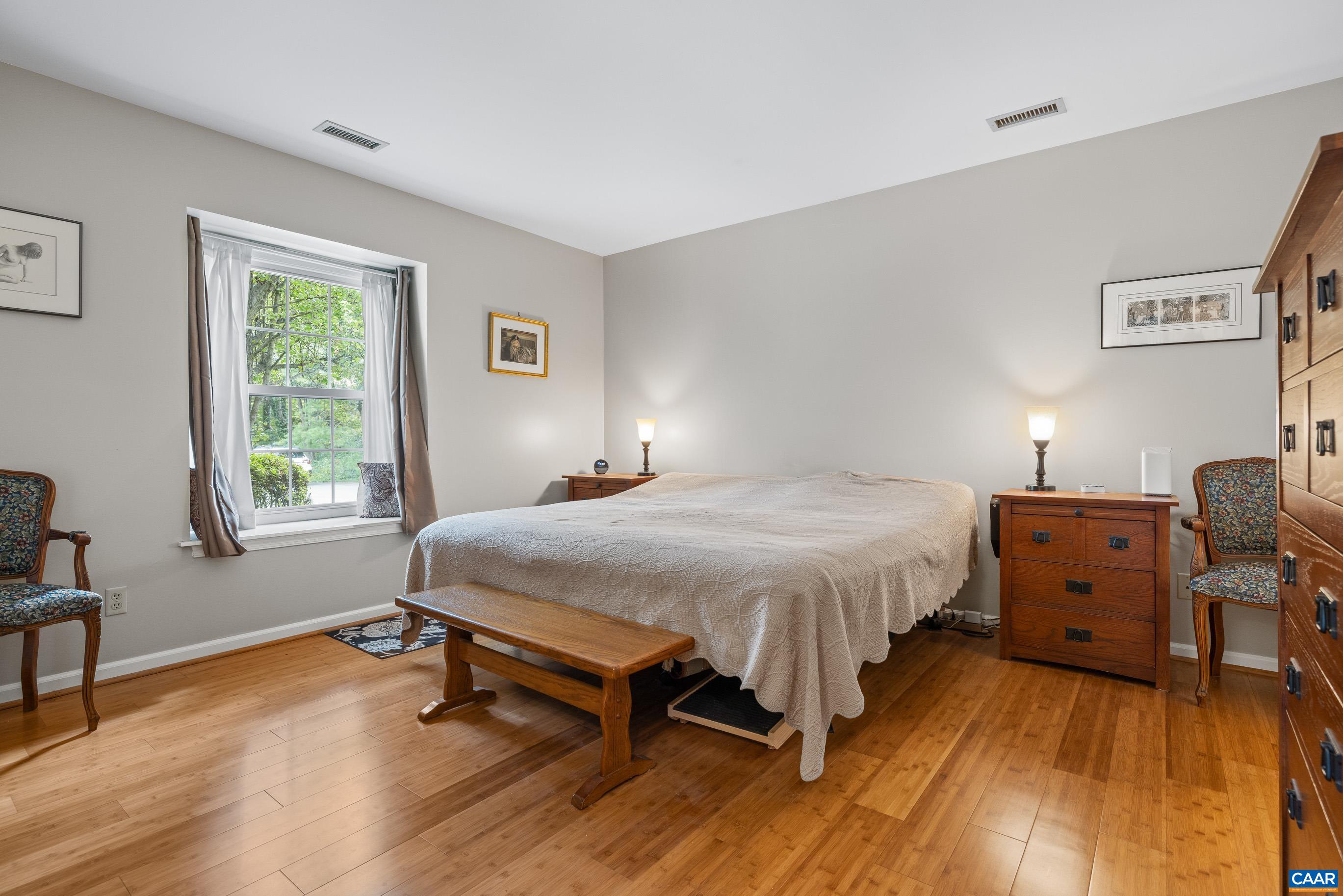 1254 Clover Ridge Place Charlottesville, VA 22901 - Photo 13 of 16 a spacious bedroom with a bed and wooden floor