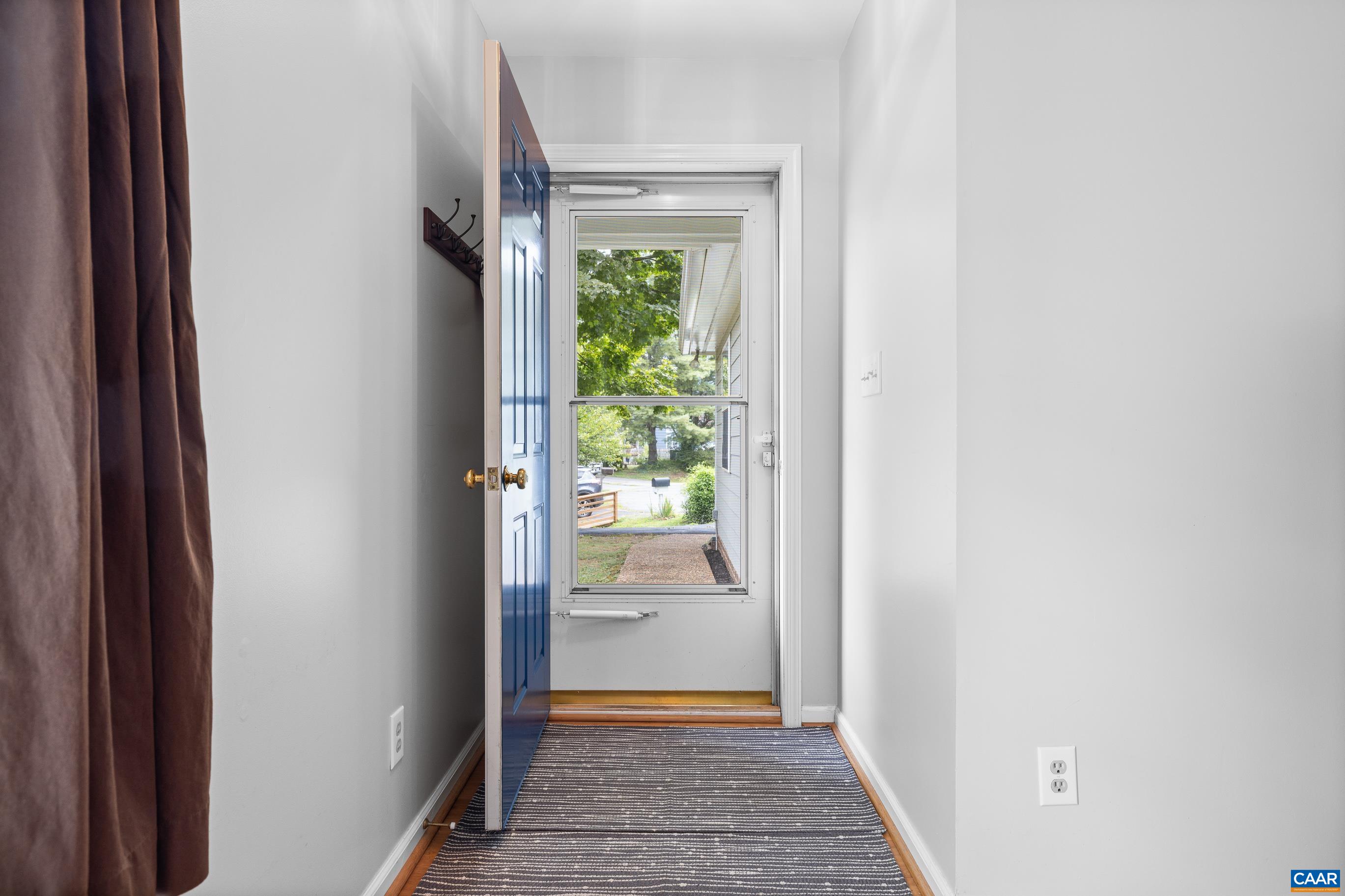 1254 Clover Ridge Place Charlottesville, VA 22901 - Photo 4 of 16 a view of a hallway with wooden floor and a dining room
