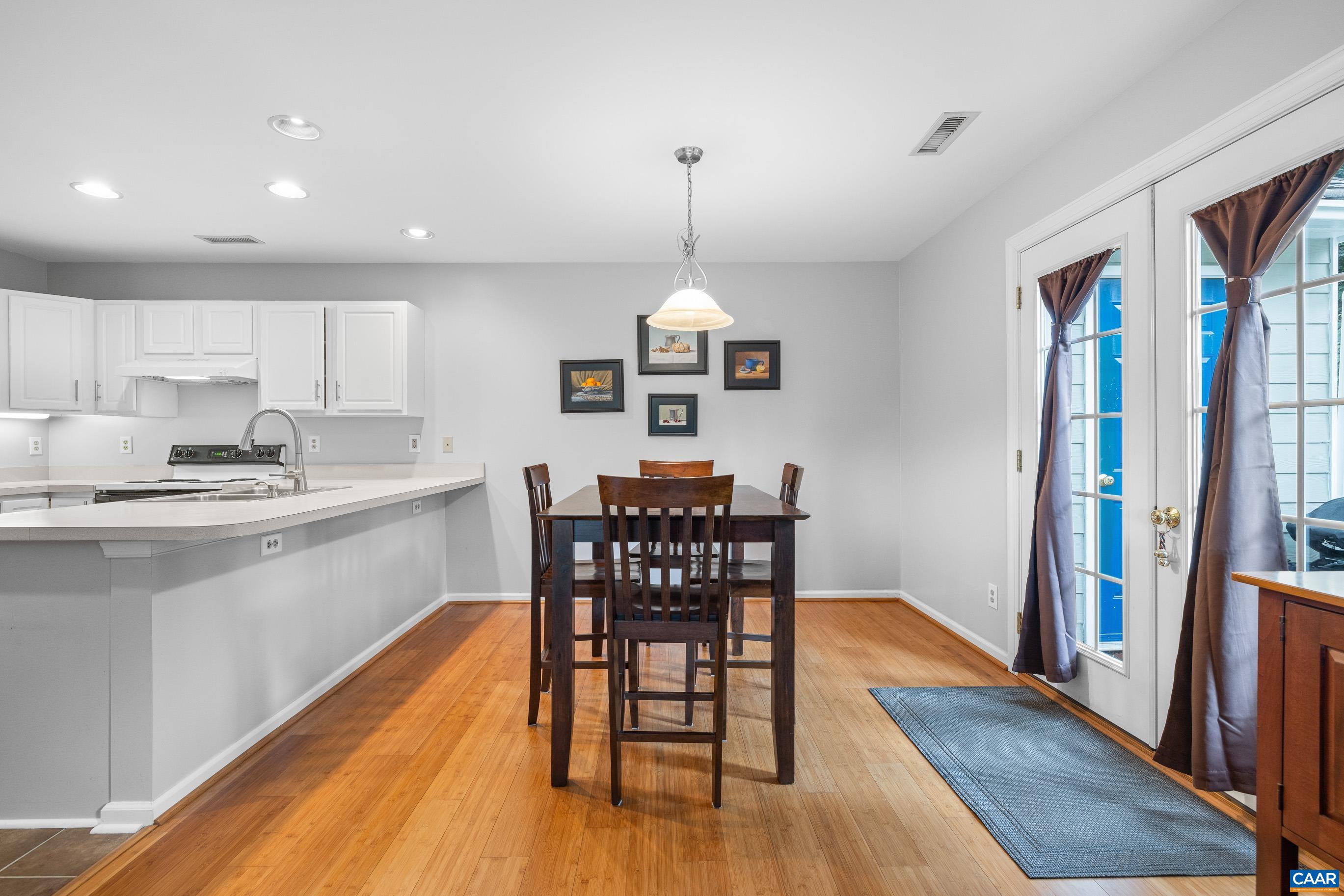 1254 Clover Ridge Place Charlottesville, VA 22901 - Photo 8 of 16 a view of a dining room with furniture window and wooden floor