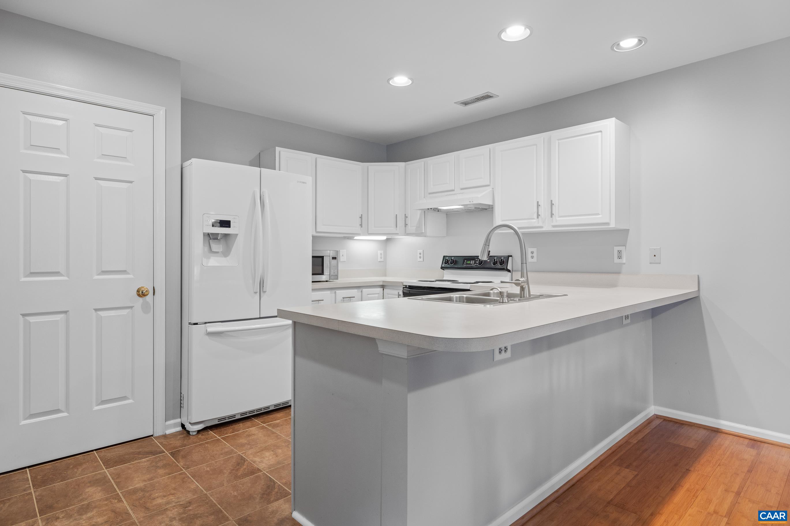 1254 Clover Ridge Place Charlottesville, VA 22901 - Photo 9 of 16 a kitchen with stainless steel appliances granite countertop a sink stove and refrigerator