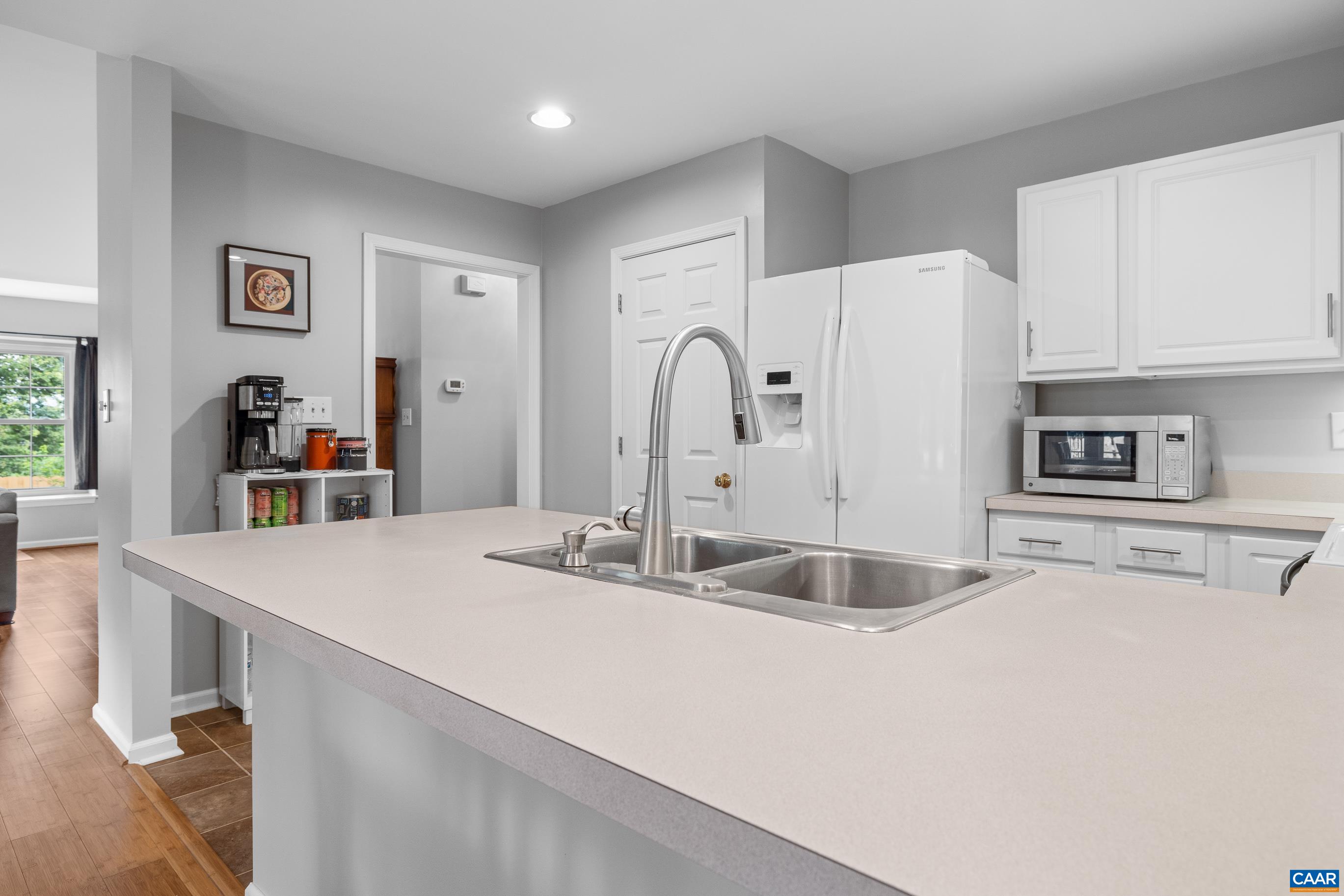 1254 Clover Ridge Place Charlottesville, VA 22901 - Photo 10 of 16 a kitchen with stainless steel appliances granite countertop a sink and a refrigerator