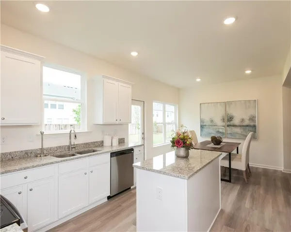 a kitchen with a sink stove and cabinets