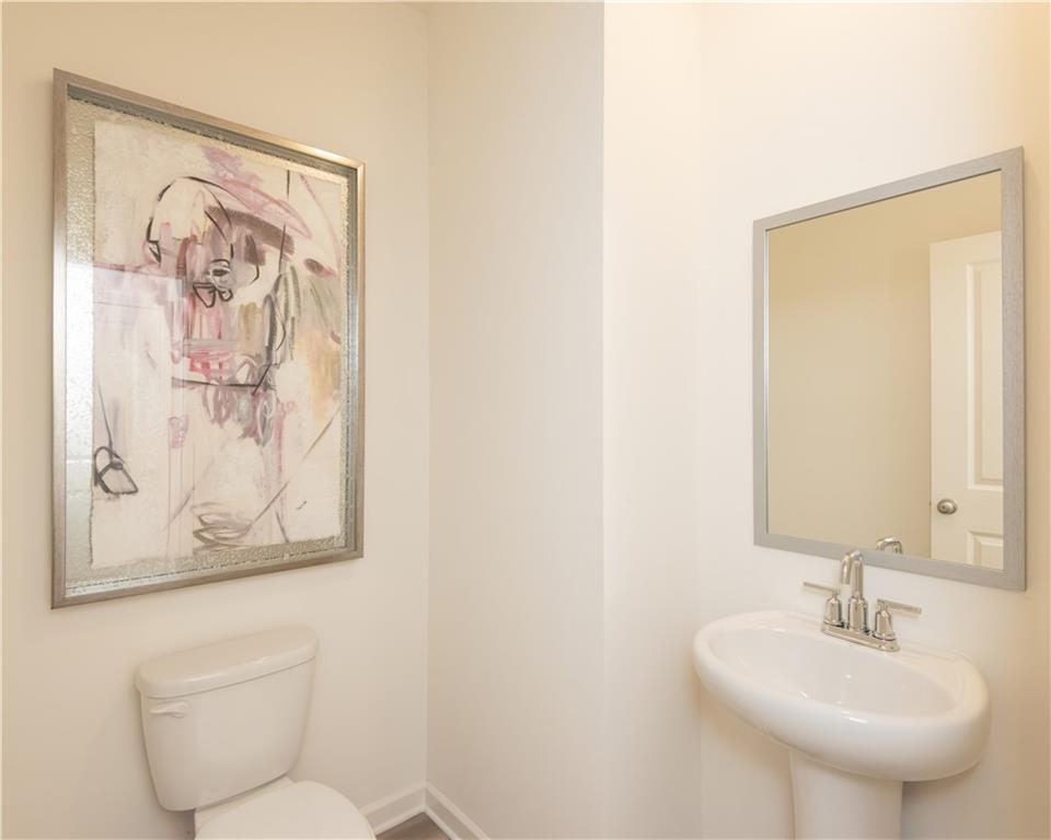 1819 Dawn Road, Unit 16 Conyers, GA 30013 - Photo 16 of 28 a bathroom with a toilet and a sink