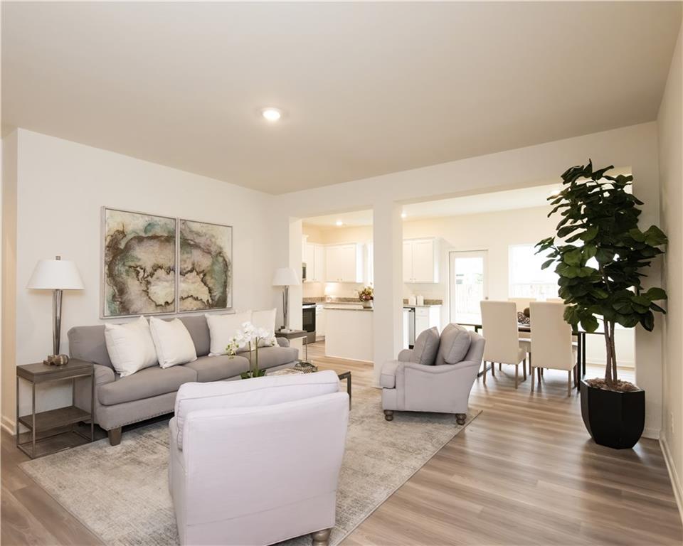 1819 Dawn Road, Unit 16 Conyers, GA 30013 - Photo 2 of 28 a living room with furniture and a chandelier