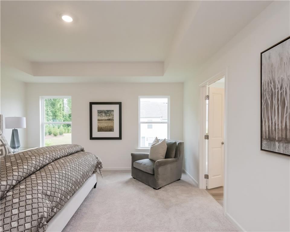 1819 Dawn Road, Unit 16 Conyers, GA 30013 - Photo 23 of 28 a spacious bedroom with a bed and a couch