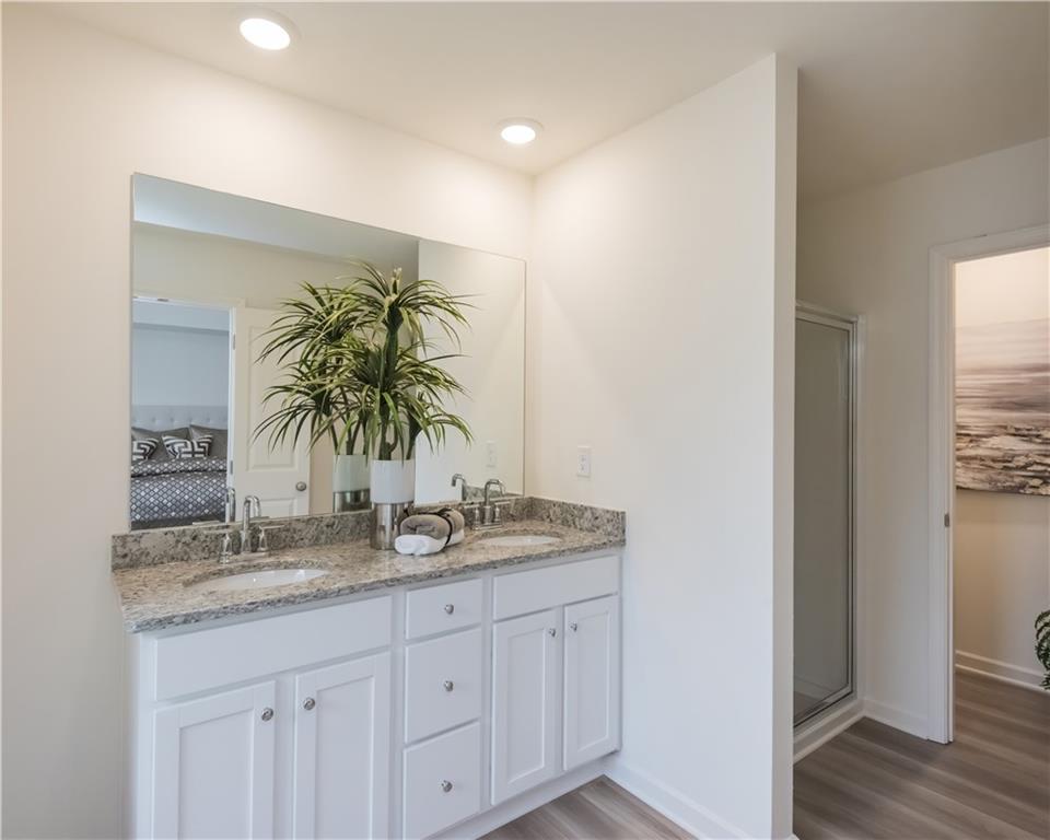 1819 Dawn Road, Unit 16 Conyers, GA 30013 - Photo 24 of 28 a bathroom with a granite countertop sink and a mirror